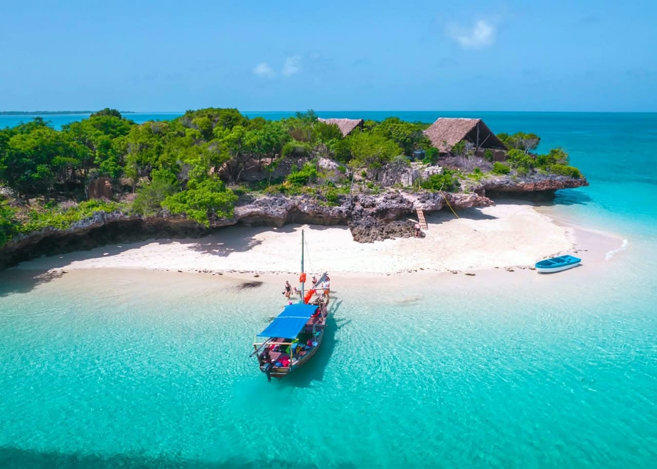 A dhow arriving at a small beach on Pemba Island, seen from above