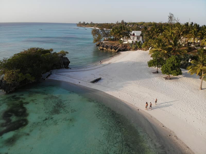 Aerial view of a beach and rocky islet on Pemba Island at golden hour